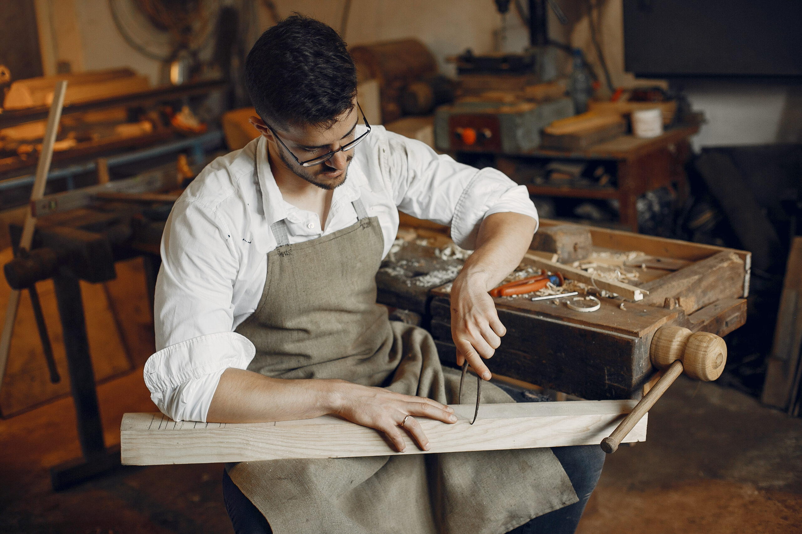 handsome carpenter working with a wood